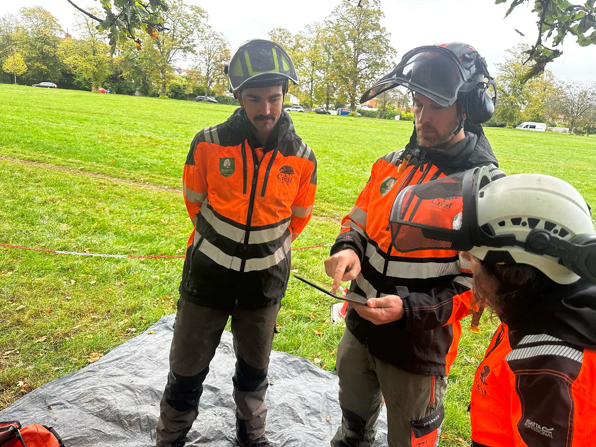 A crew member signing a site risk assessment on a device