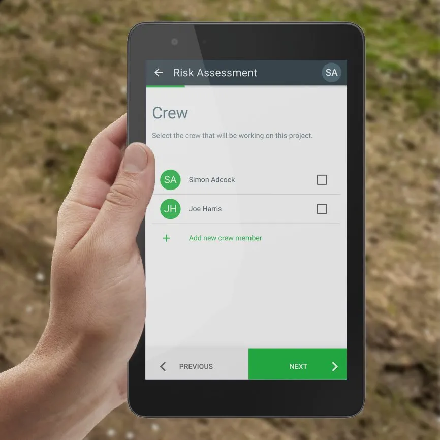 A crew member completing a risk assessment on an iPad